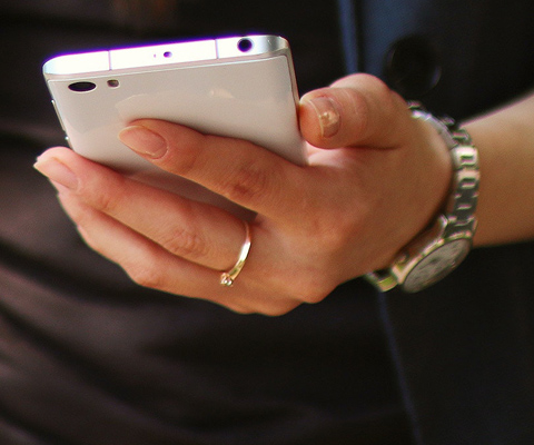 Close up photo of woman's hand holding a mobile phone