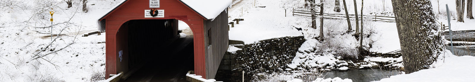 Scenic winter photo of a red covered bridge