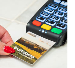 photo of debit card being inserted into card processing machine