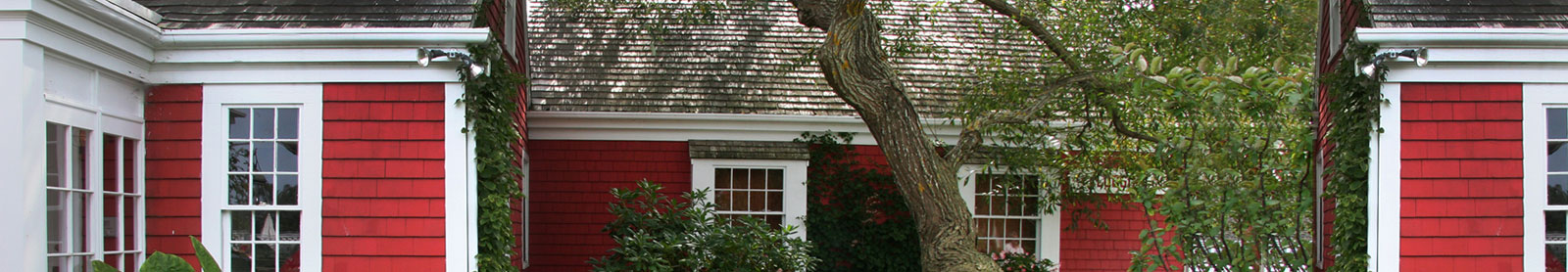 Cropped photo of red house with white trim
