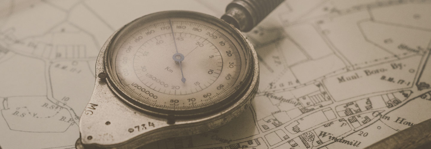 Close up image of compass over a map background