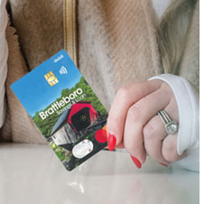 Close up photo of woman's hand holding a debit Mastercard