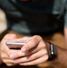 Close up photo of a man's hands holding a mobile phone