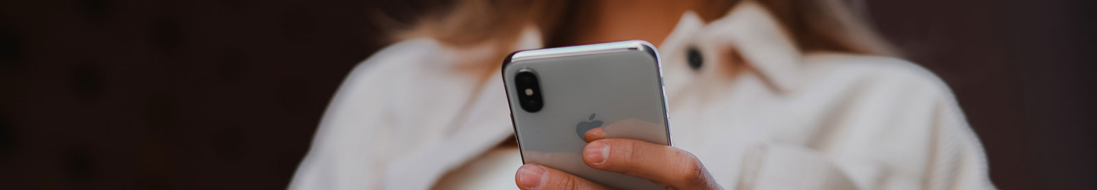 Cropped photo of a woman holding an iPhone