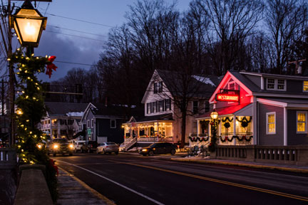 Evening photo of downtown Wilmington with holiday garlands and decorations on local businesses and lamp post