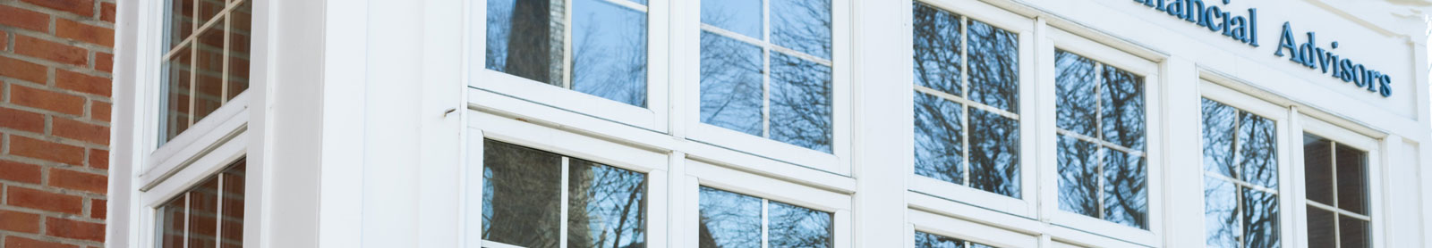 Cropped close up photo of windows on the front of Park Place Financial Advisors building