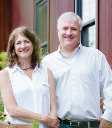 Photo of a couple standing in front of a business