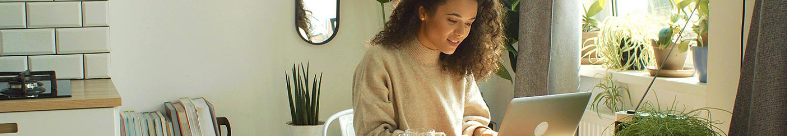 Woman using laptop in kitchen