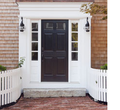 photo of black front door of home with weathered cedar shake siding