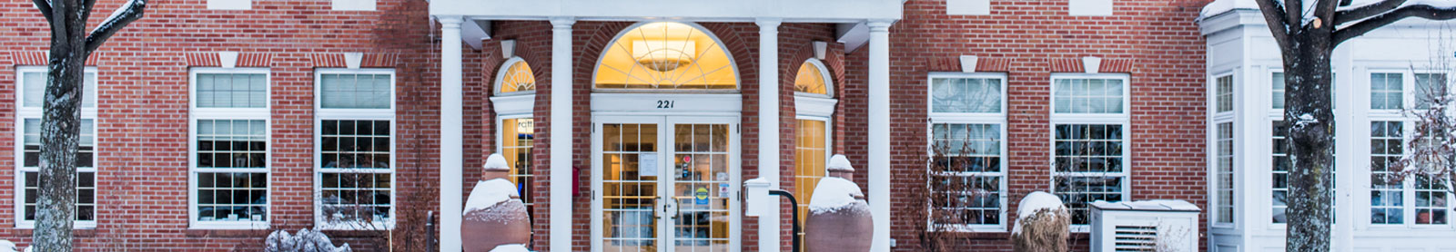 Cropped photo of BS&L's main office, with brick facade and white columns