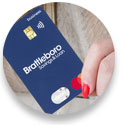Close up photo of person's hand holding a blue BS&L business mastercard 
