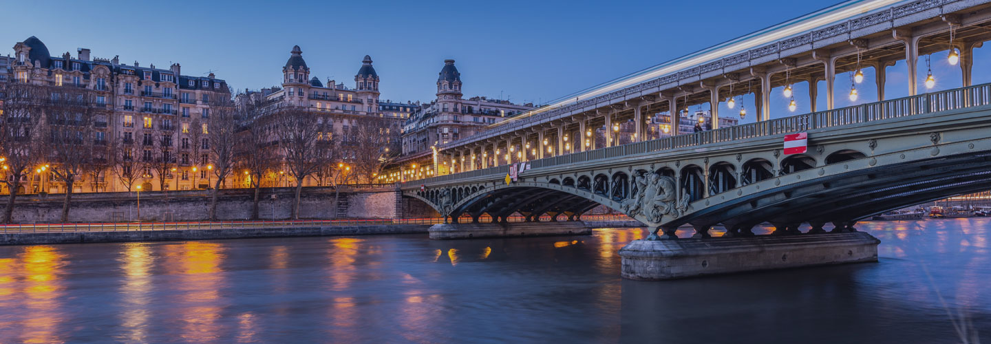 beautiful scenic photo of European buildings overlooking the water with reflection of building lights on the water